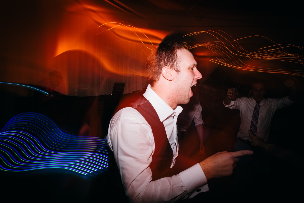 Groom dances as he sings along to a song at the wedding at the Hunter Museum.
