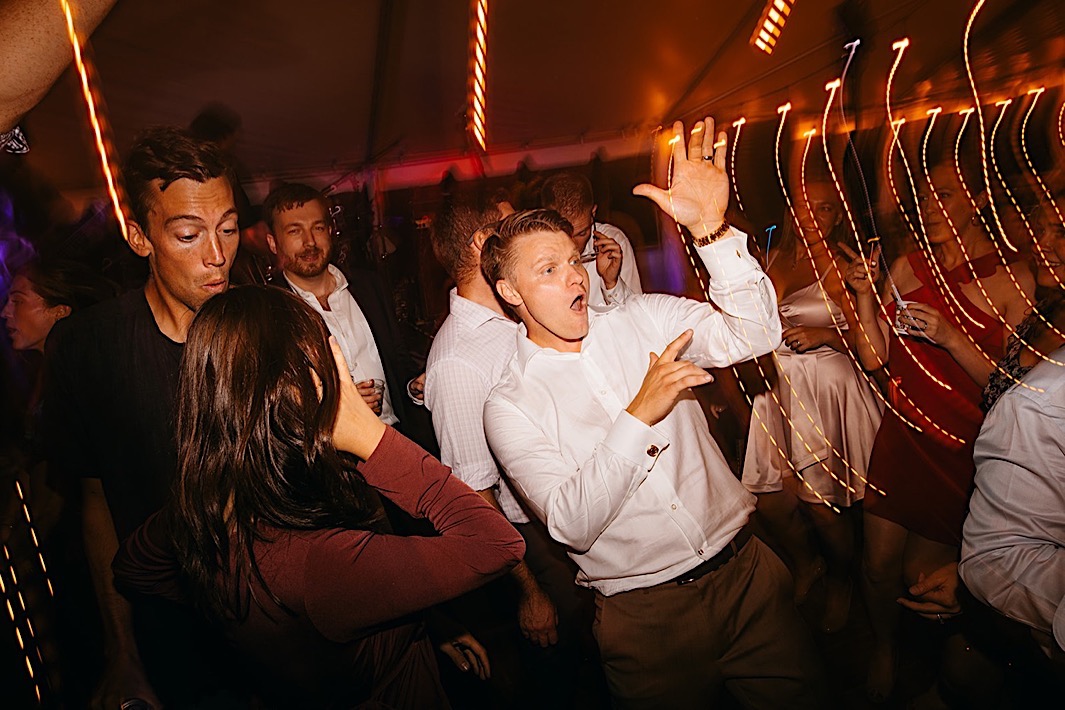 People dancing on a crowded dancefloor at night.