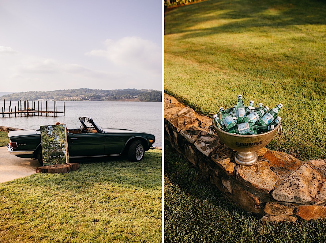 A mirror sign leaning against a vintage car parked next to a lake. A silver bowl full of bottles of sparkling water.