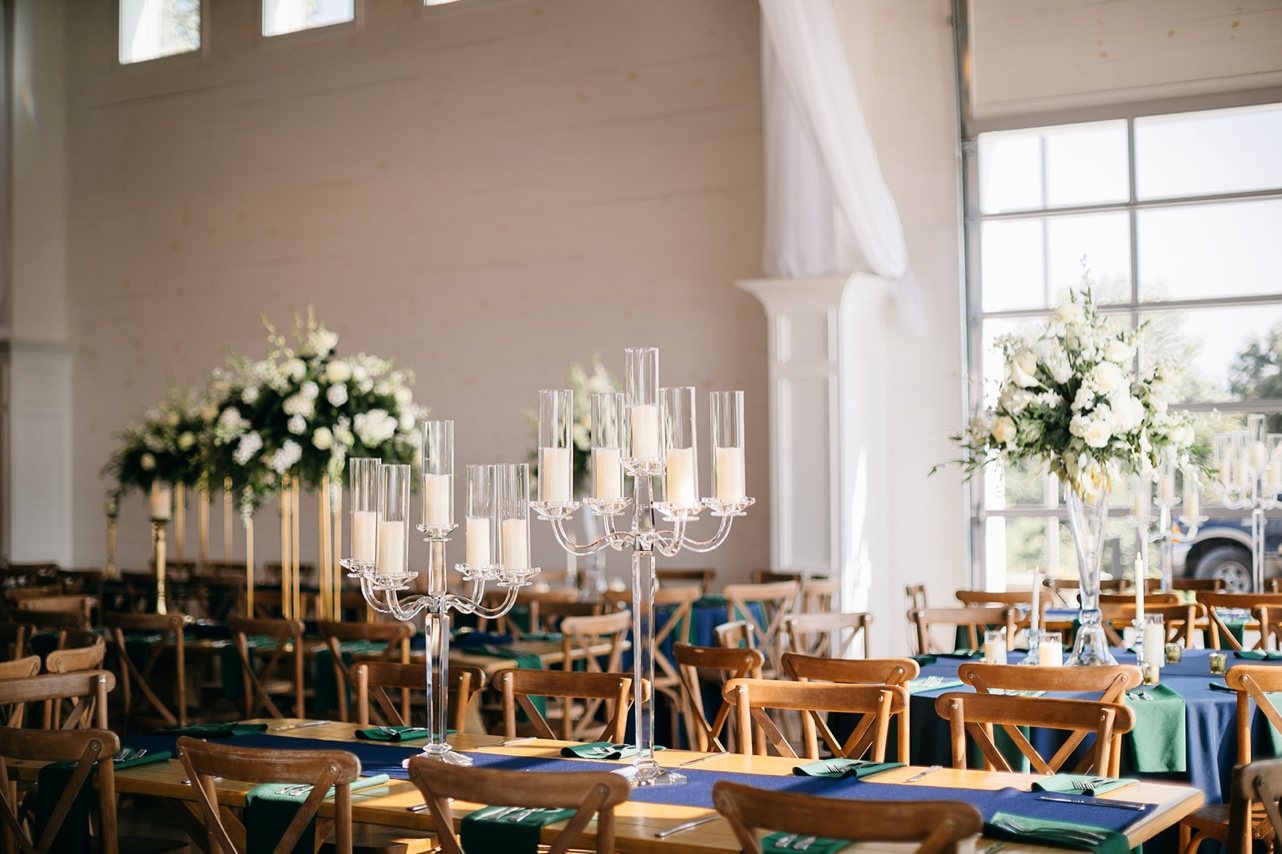 Two glass candelabras are pictured on a table at the Howe Farms wedding reception.