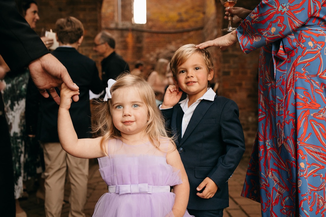 Barnsley Resort Wedding Photographer shares a darling shot of two children in the ruins with parents at hand