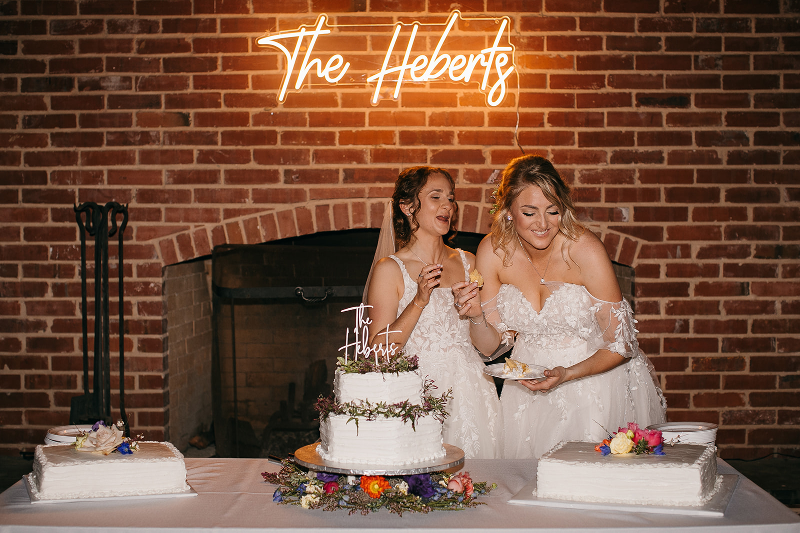 Feeding each other cake at an LSU Botanic Gardens wedding reception