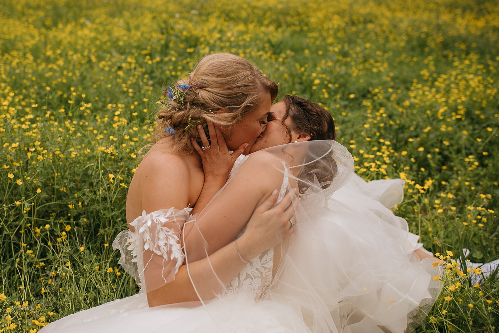 Couple kissing in field of flowers together during portraits at their LSU Botanic Gardens wedding
