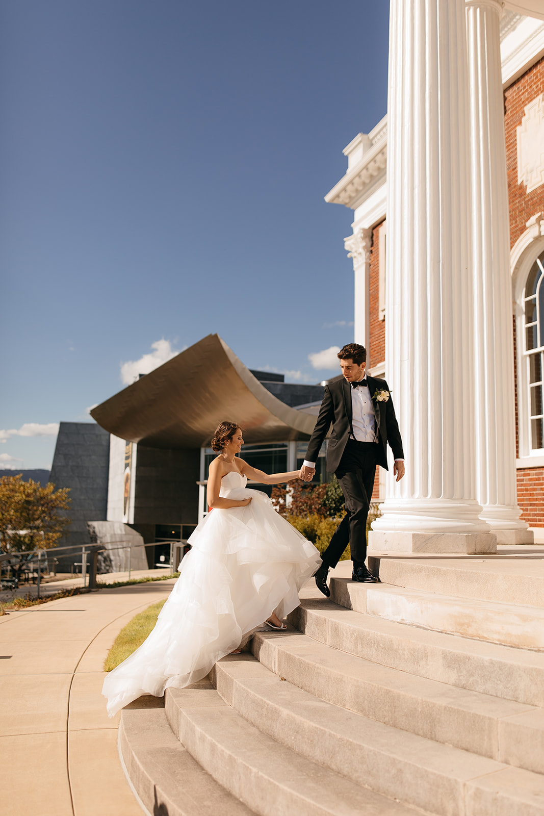 Bride and groom walk up the stairs together at a unique outdoor wedding venue in Chattanooga, TN. 