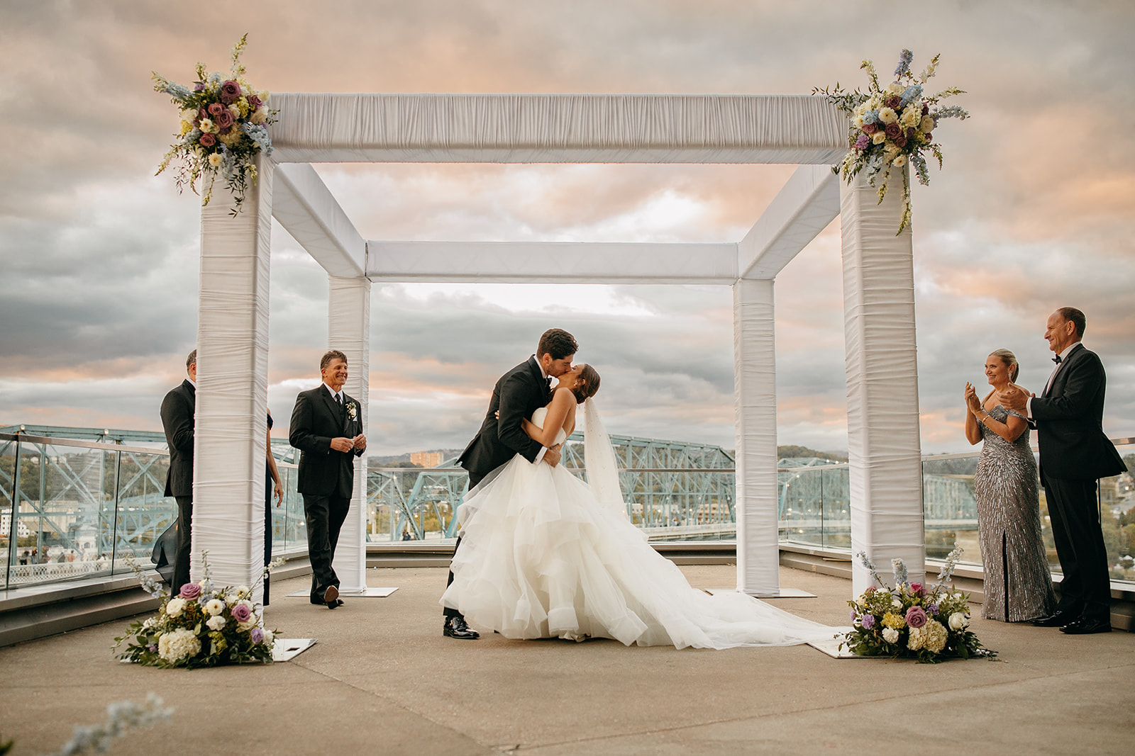 ​Bride and Groom exchange first married kiss at one the best outdoor wedding venues in Chattanooga with beautiful views in the background. 