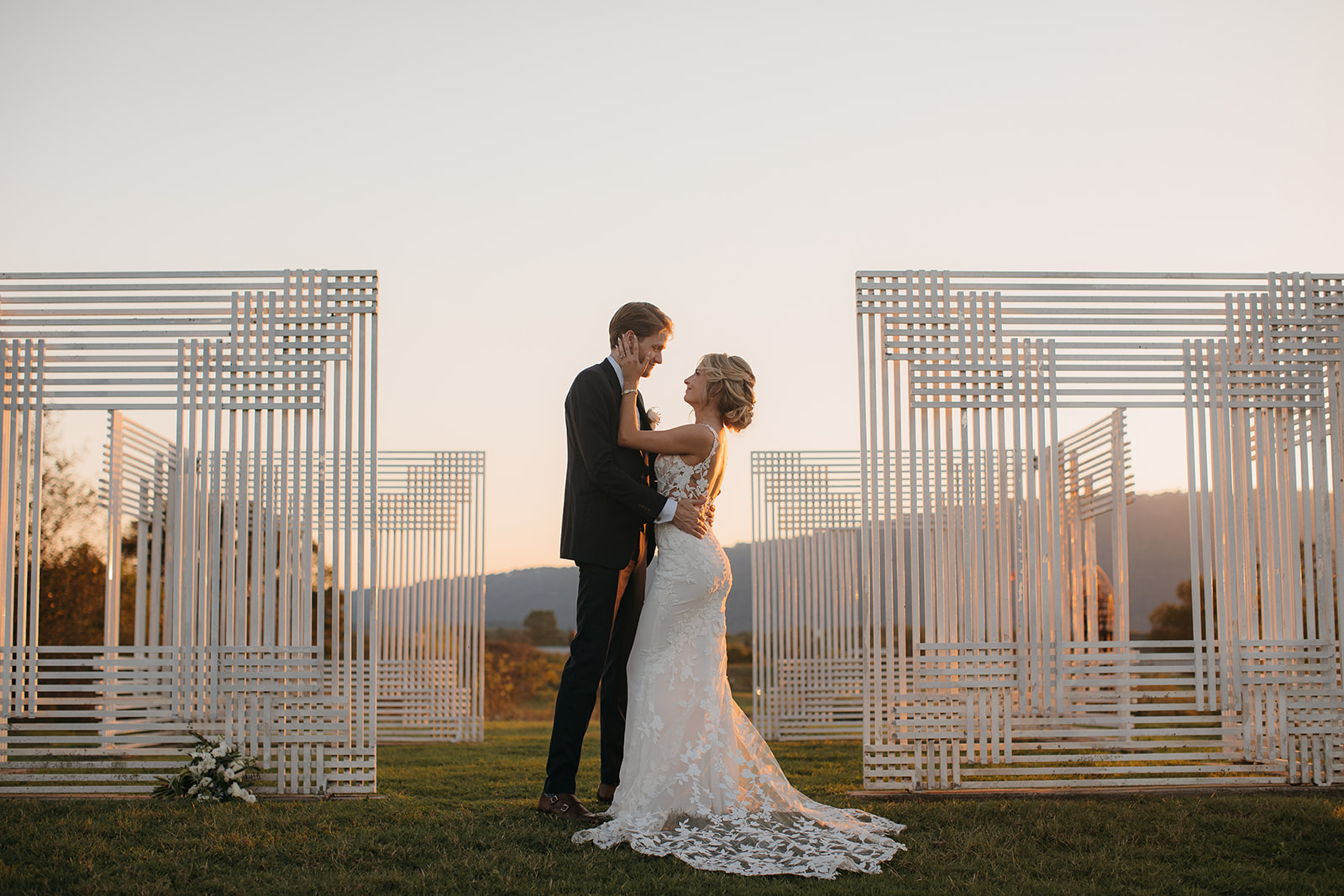 Bride and Groom pose among sculptures at sunset for at a beautiful wedding venue in Chattanooga, TN outdoor. 
