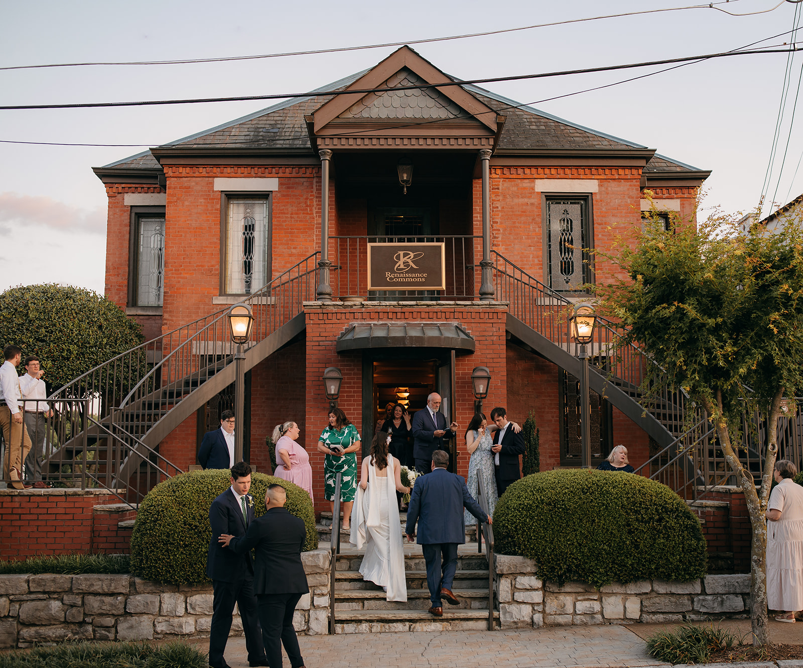 Candid bride and groom portrait walking up the stairs with guests at one of the best wedding venues Chattanooga ,TN outdoor. 