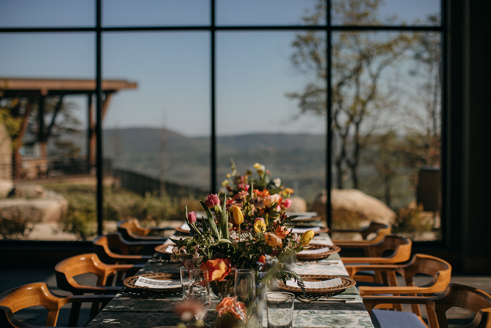Gorgeous mountain views through large windows with lovely table setting in the forefront at outdoor wedding venues in Chattanooga TN. 