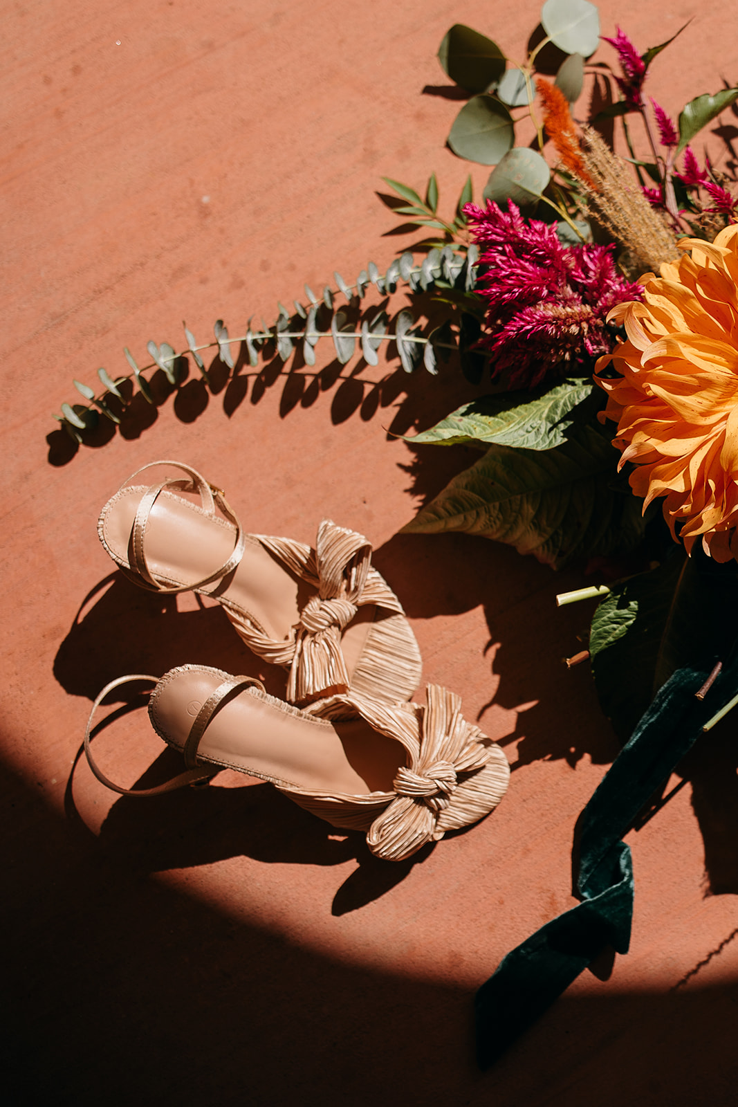 Wedding details with bridal shoes and bouquet styled at Tennessee River Place.