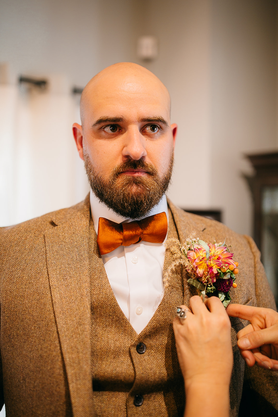 Groom adjusting boutonniere before the ceremony at Tennessee River Place in Chattanooga. 