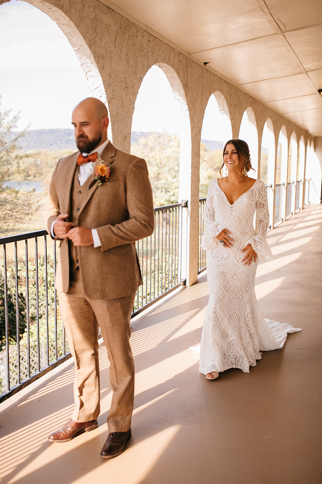 First look moment on the balcony overlooking the river at Tennessee River Place wedding. 
