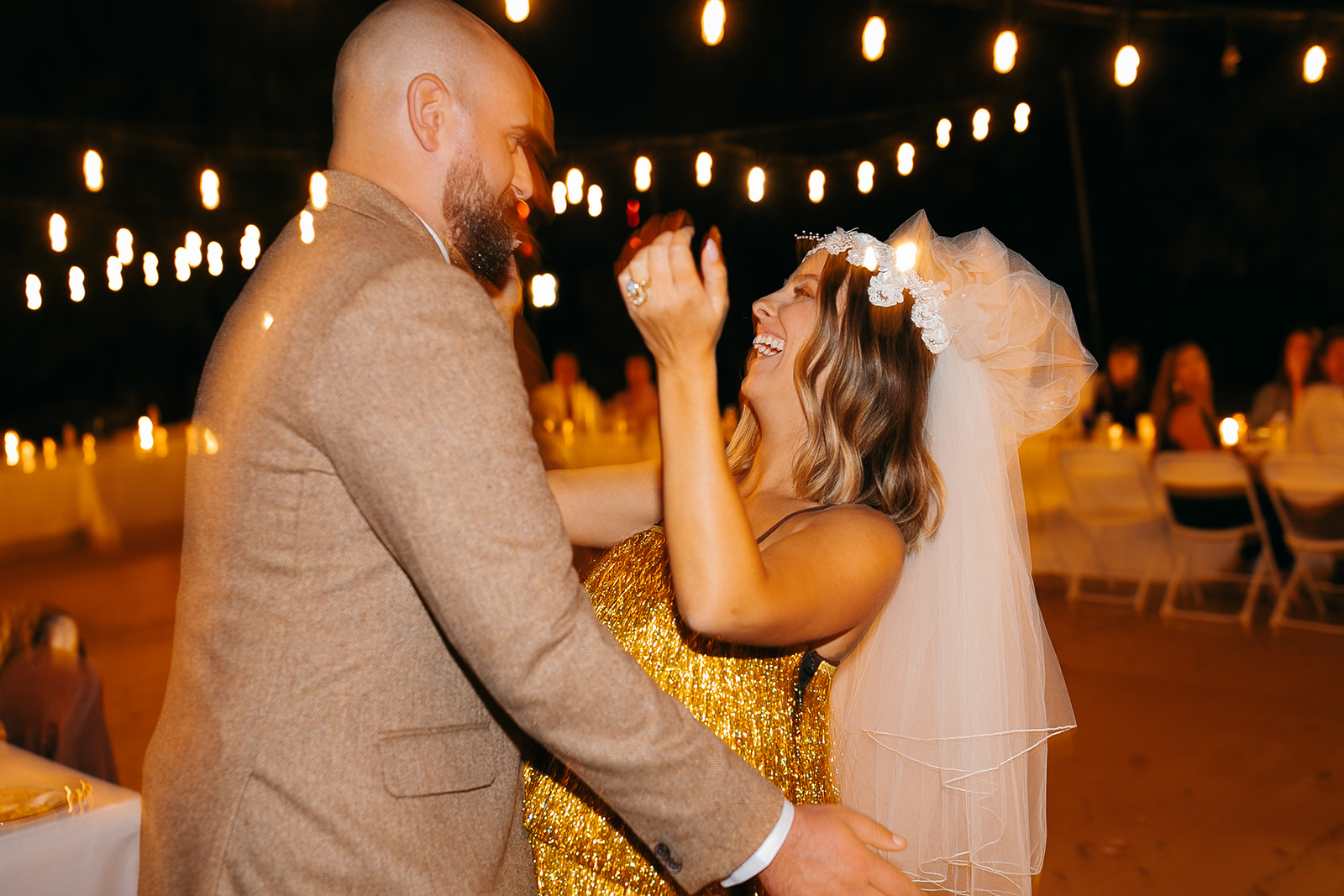 Bride and groom dancing under string lights at Tennessee River Place wedding reception. 