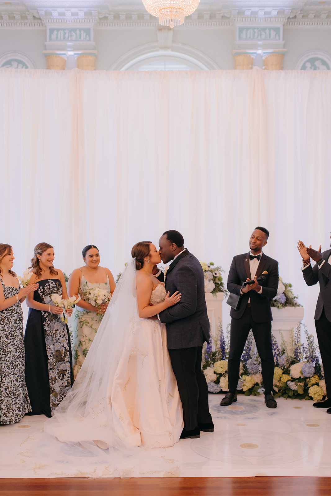 Bride and groom sharing their first kiss during their Atlanta Biltmore Ballrooms wedding ceremony. 