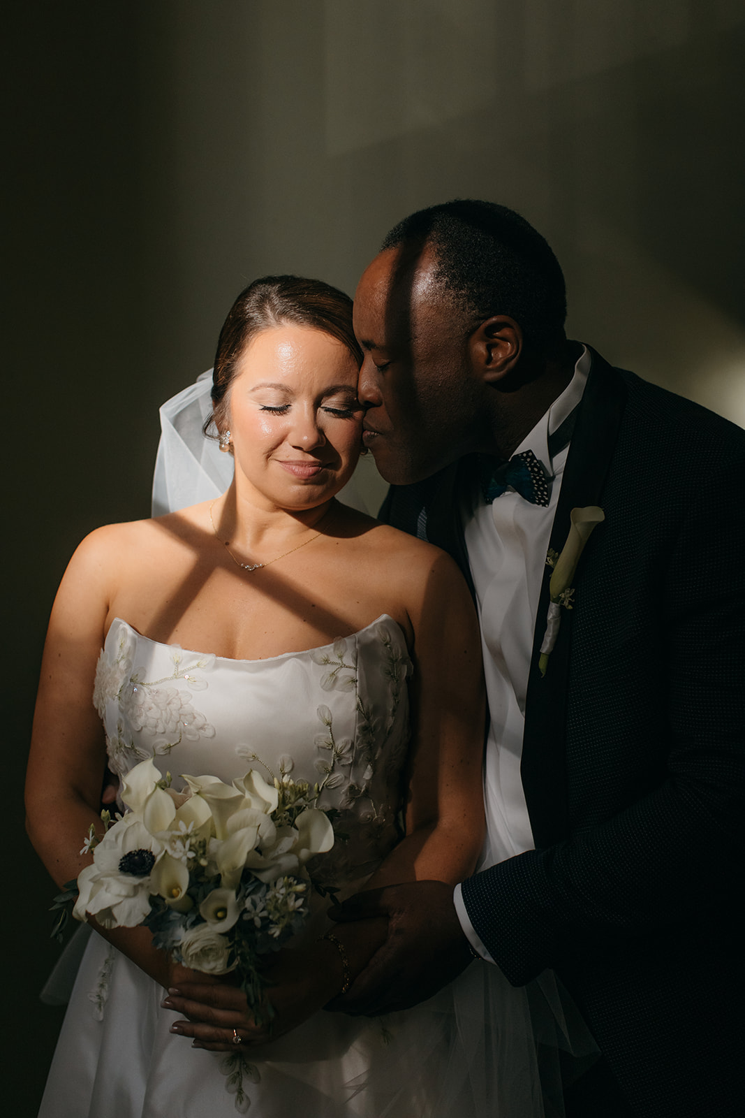 Romantic portrait inside the Biltmore Ballroom Atlanta with dramatic light and shadows across the couple. 
