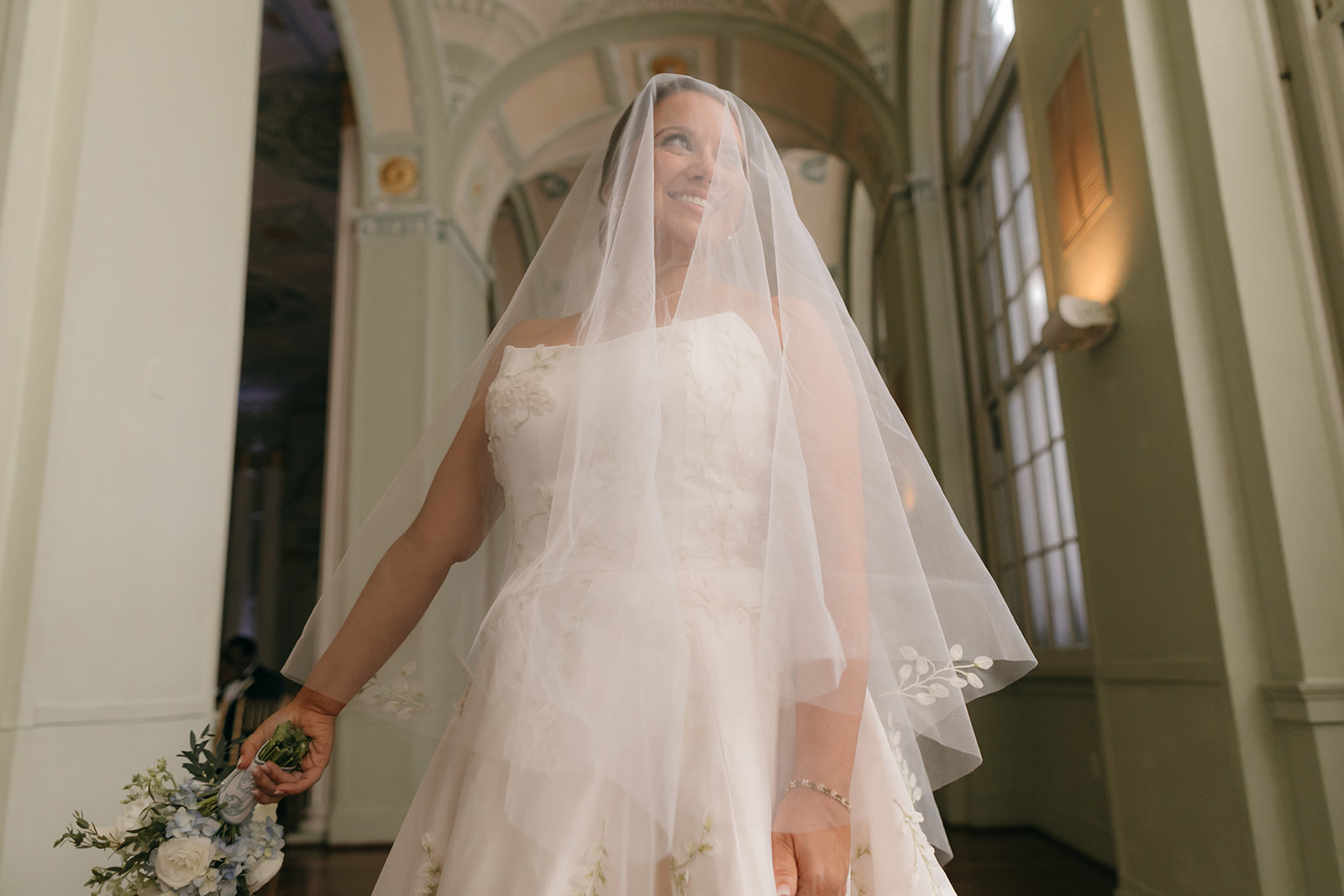 Bride portrait inside the historic Biltmore Hotel Atlanta ballroom with arched windows and detailed ceilings. 