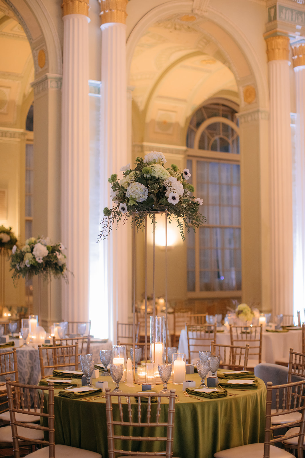 Reception space inside the elegant Biltmore Ballroom Atlanta GA with candlelit tables and grand chandeliers