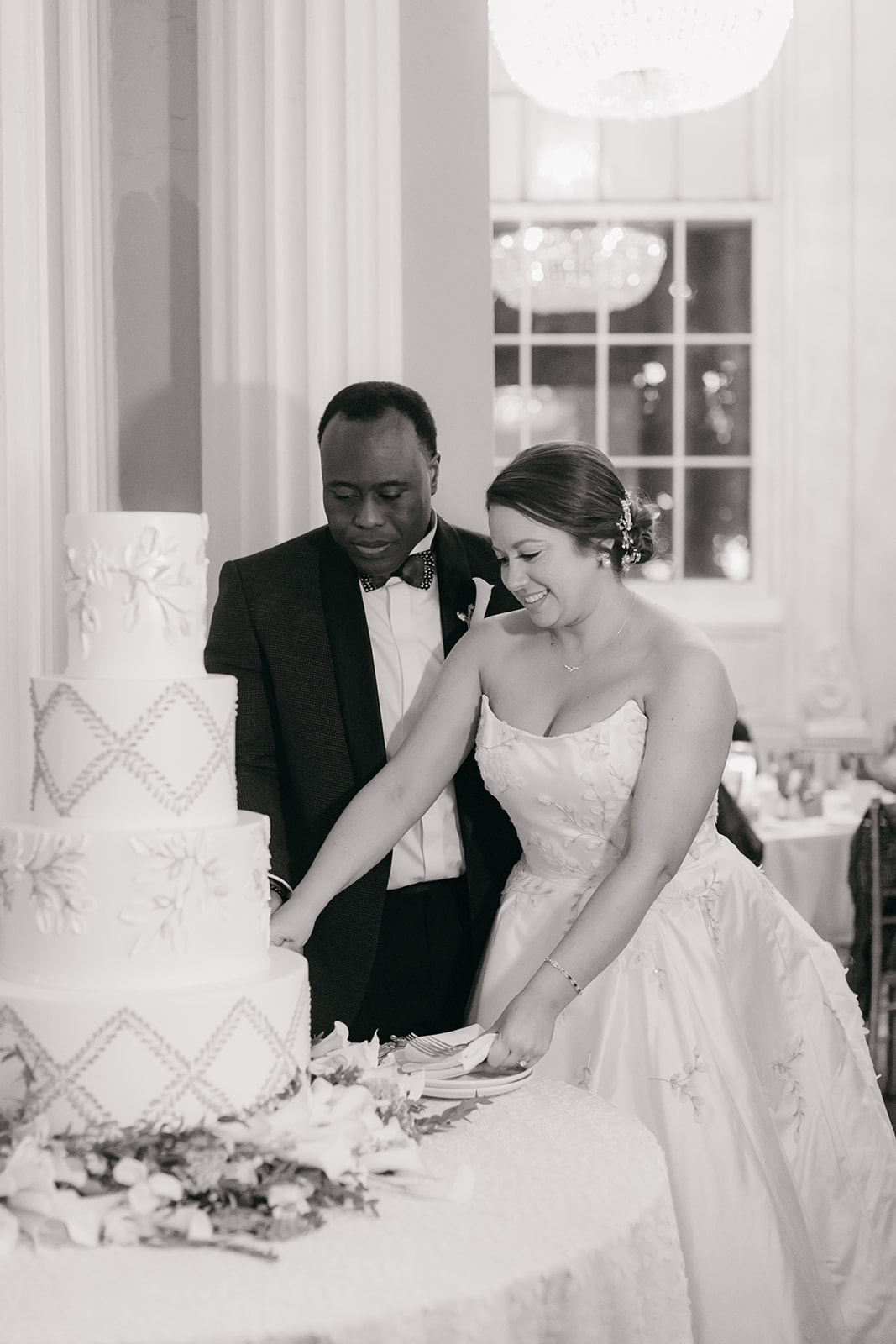 Bride and groom feeding each other cake during their wedding reception at the Biltmore Ballrooms Atlanta. 