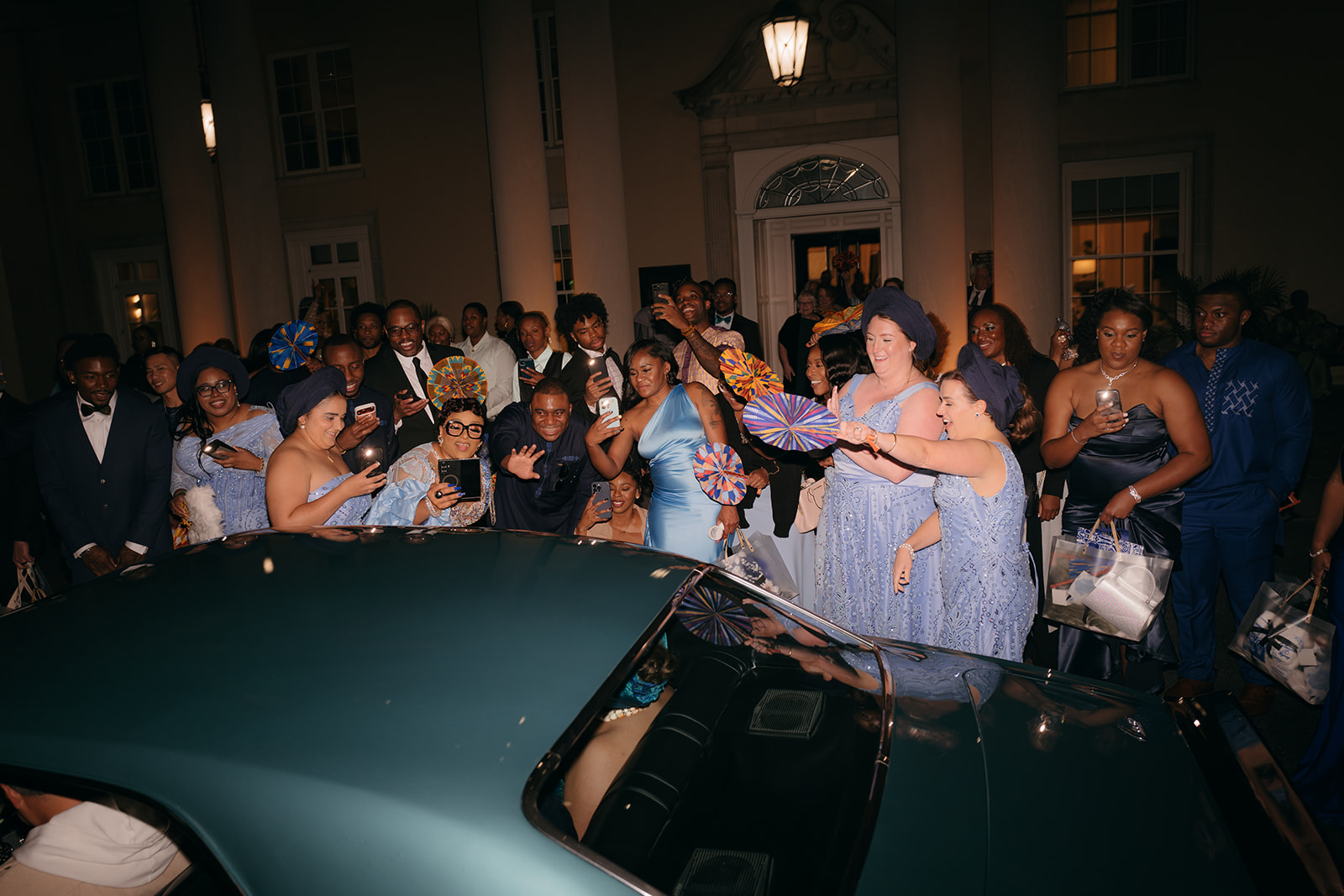 Wedding guests celebrating the couple’s grand exit outside the Biltmore Ballrooms Atlanta at night. 
