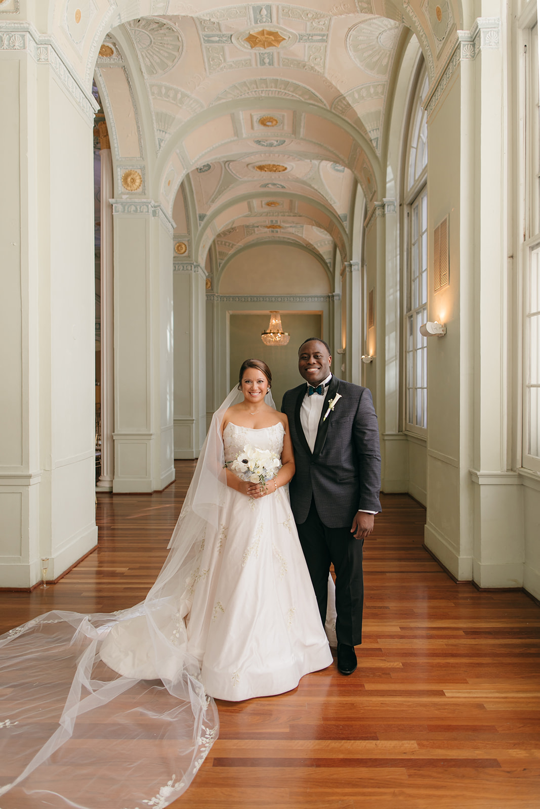 Bride and groom portrait inside The Biltmore Ballrooms Atlanta with historic arches and natural window light