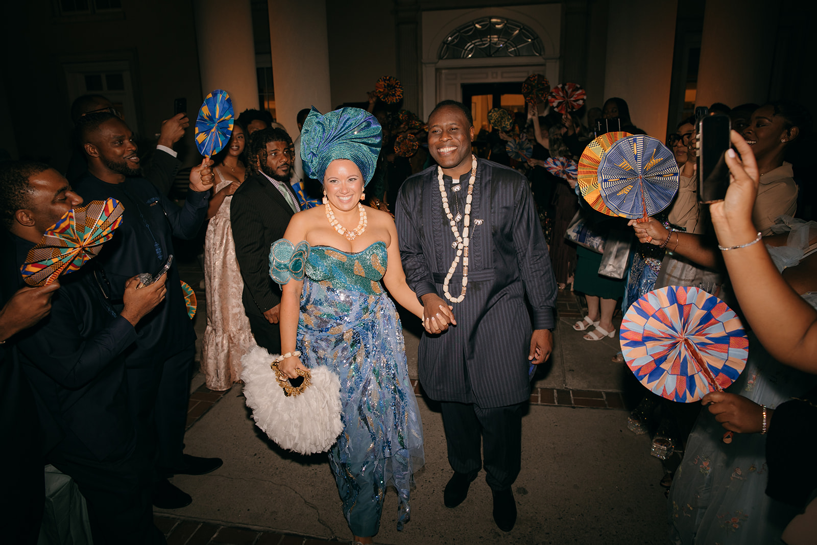 Wedding reception exit at the Biltmore Ballroom Atlanta with colorful fans and Nigerian cultural attire. 