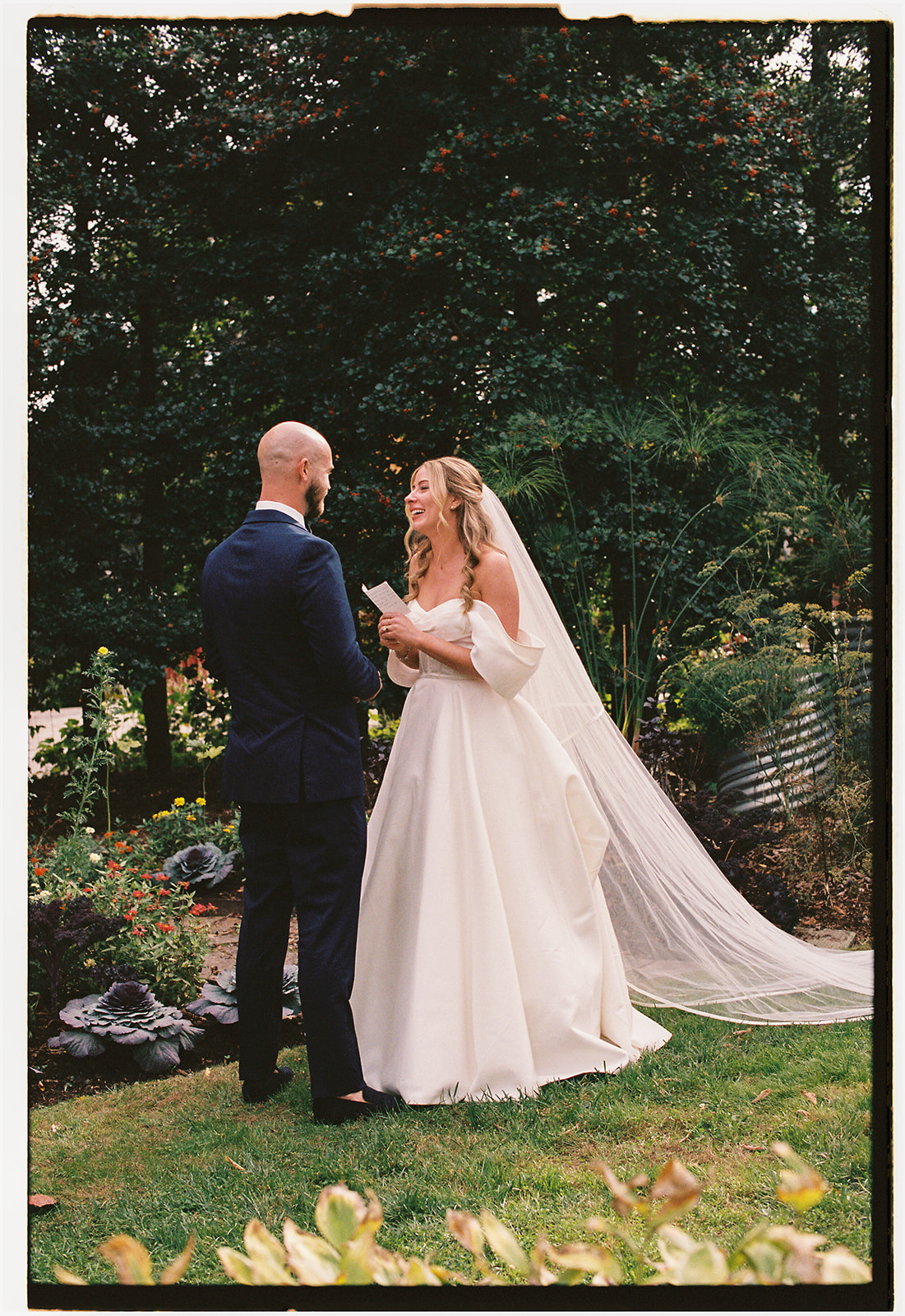 Bride and groom sharing private vows among the gardens at one of the most beautiful garden wedding venues NC has to offer. 