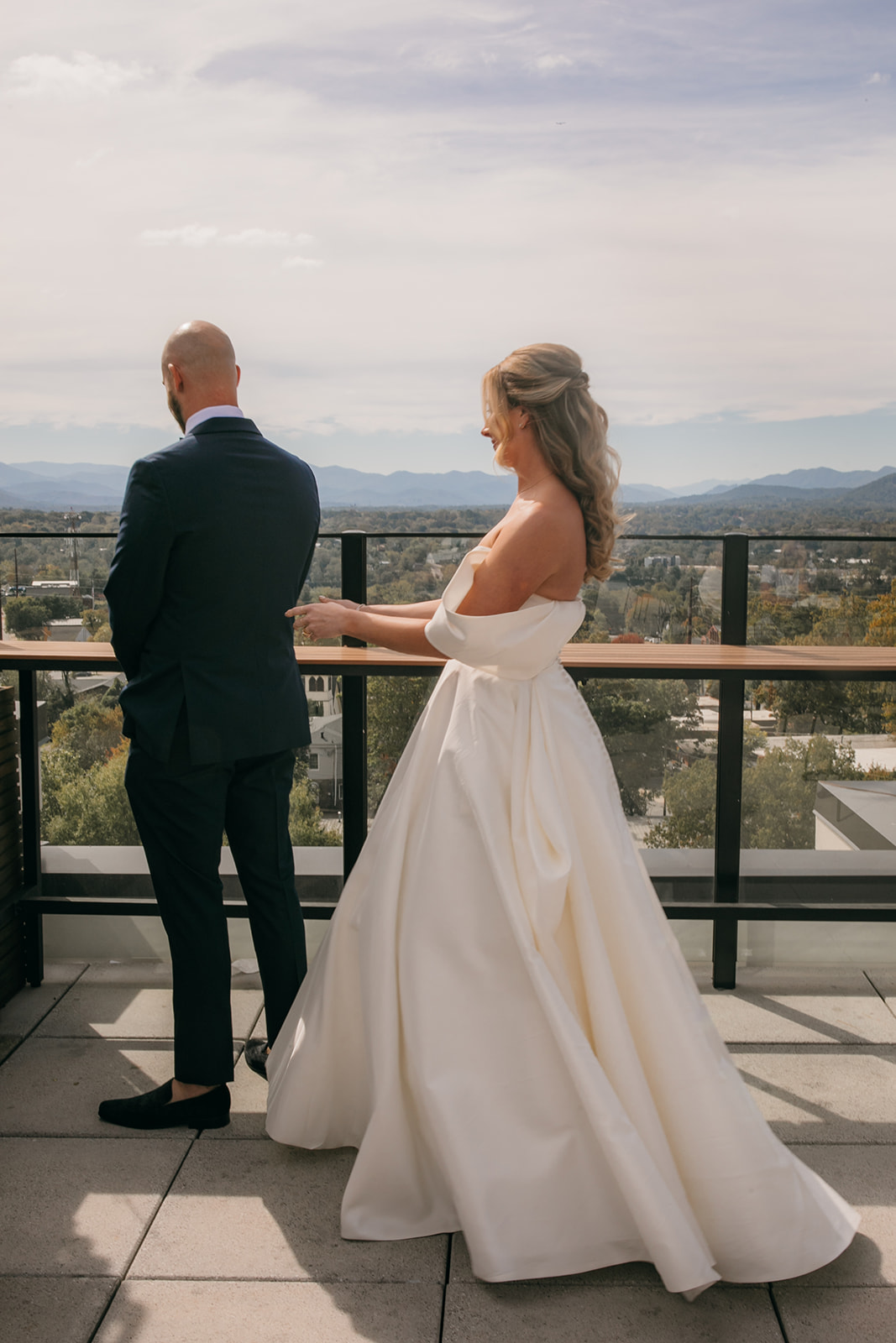 Bride and groom sharing a first look with mountain views before their North Carolina Arboretum wedding. 