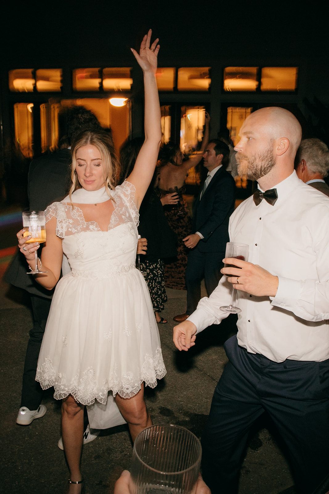 Bride and groom dancing with guests during an NC Arboretum weddings reception celebration. 