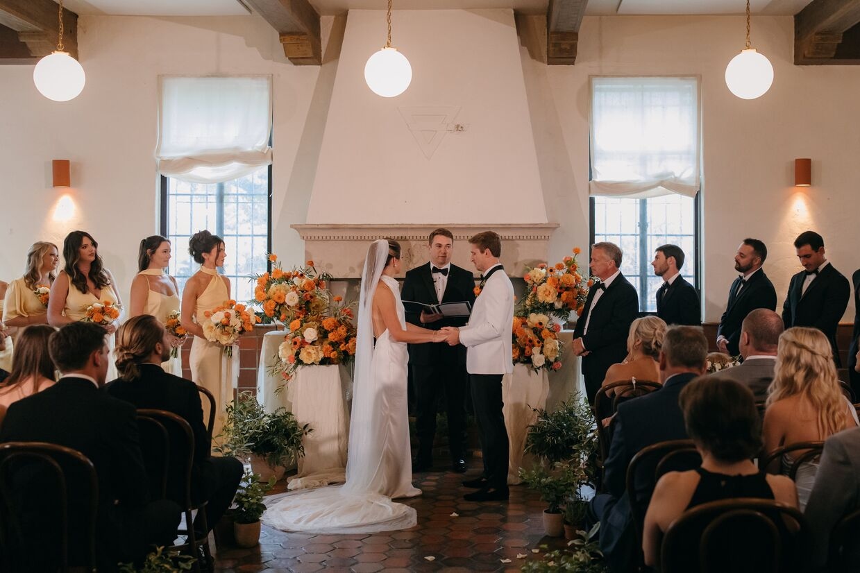 bride and groom standing in front of crowd at ceremony at common house chattanooga