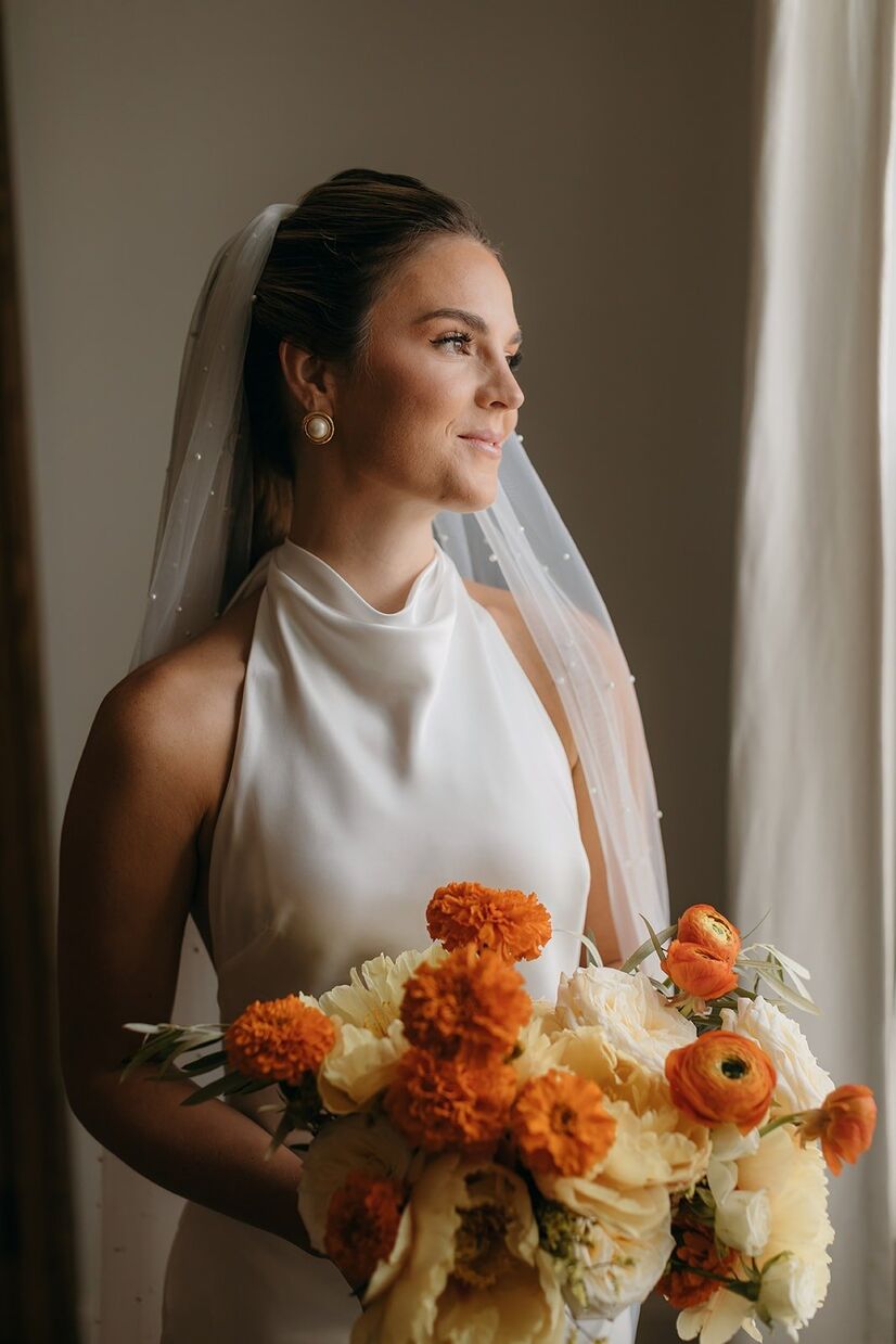 bride at common house chattanooga looking out window with light hitting her face