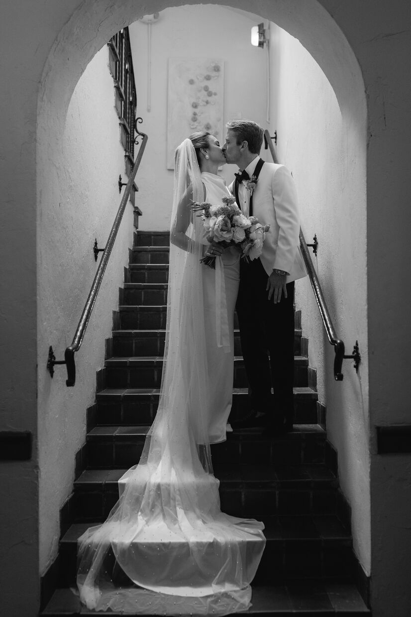 black and white photo of couple standing on staircase at common house chattanooga