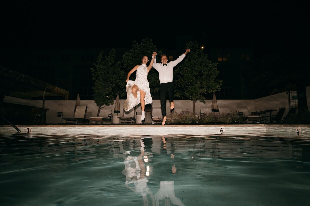 bride and groom jumping into pool after reception at common house chattanooga