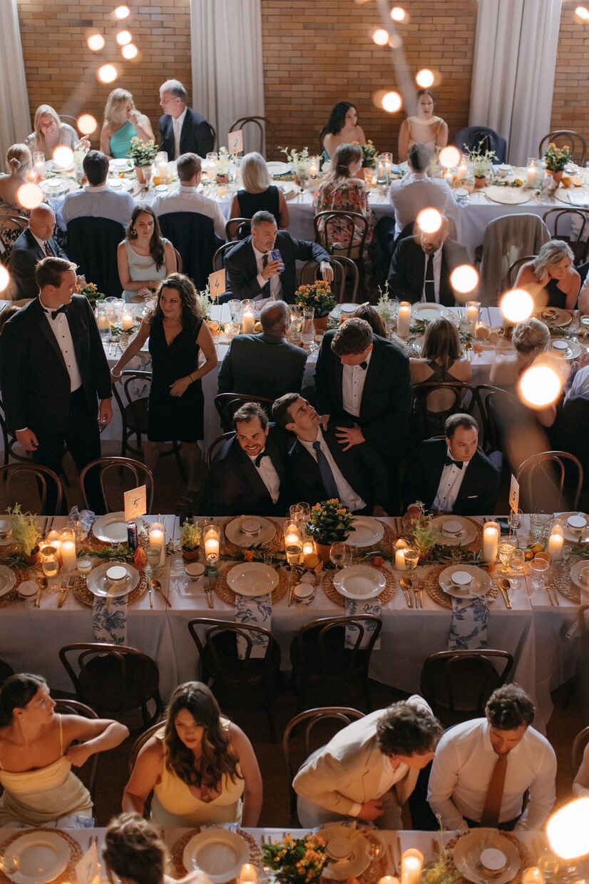 guests mingling at elegant linen tables with twinkle lights above them at common house chattanooga
