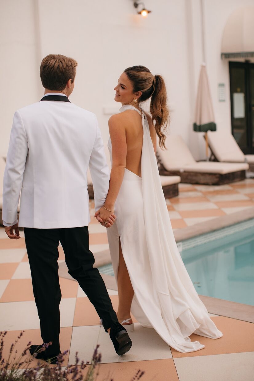 bride and groom walking by pool after ceremony at common house chattanooga