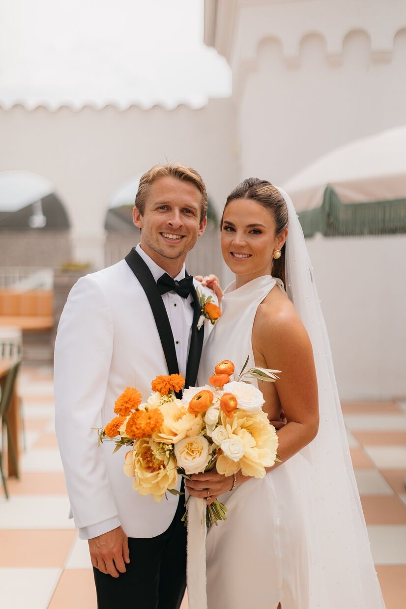 bride and groom smiling at camera on terrace at common house chattanooga