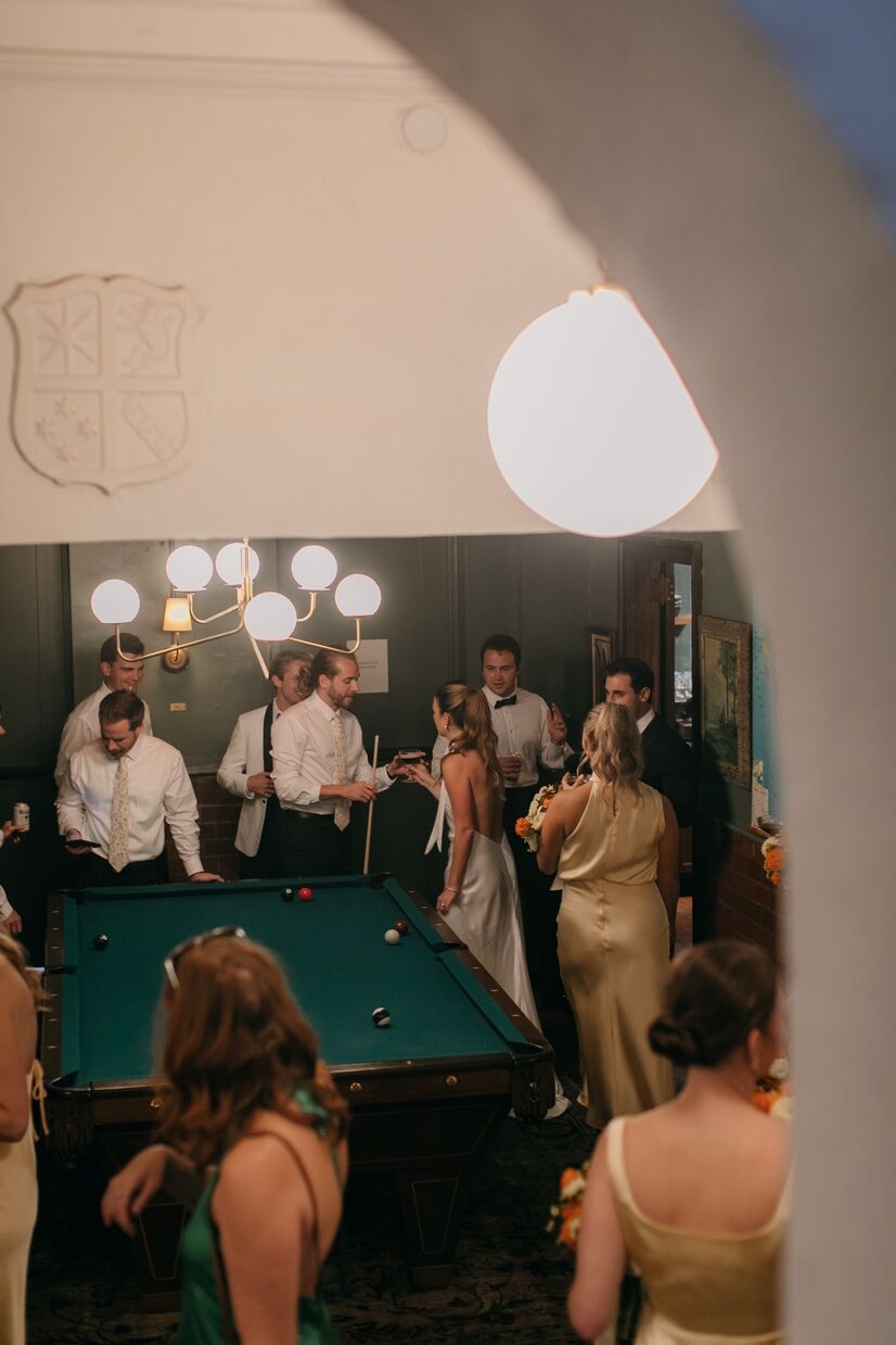 wedding party mingling and playing pool at common house chattanooga
