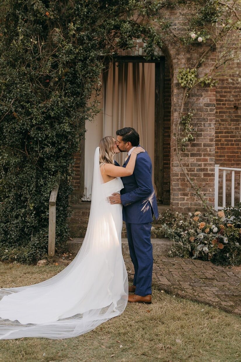 Bride and groom kissing at a Barnsley Garden wedding.