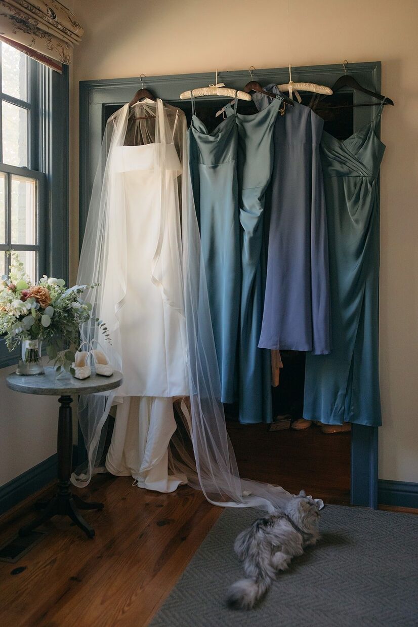 Bride's dress and bridesmaid dresses hanging up for a Barnsley Gardens wedding.