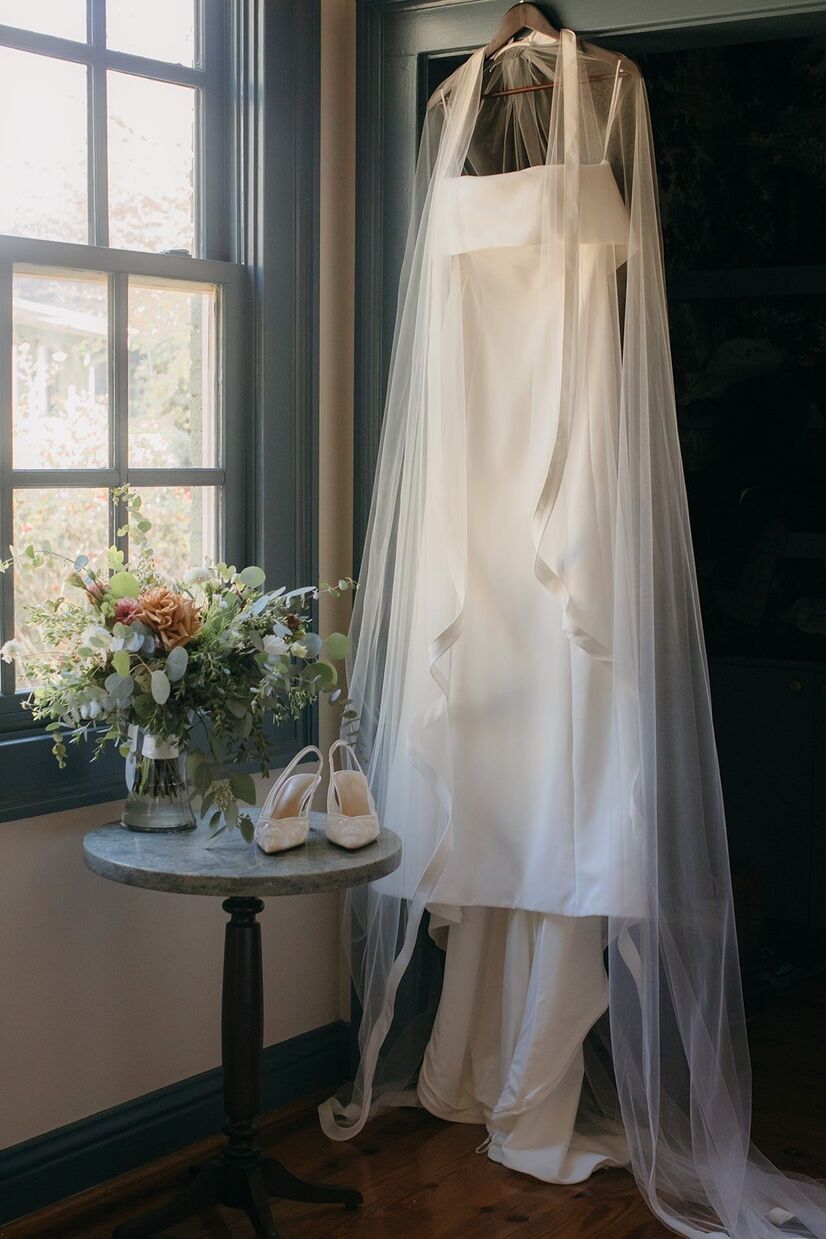 Brides dress hanging up in cozy room for a Barnsley Gardens wedding
