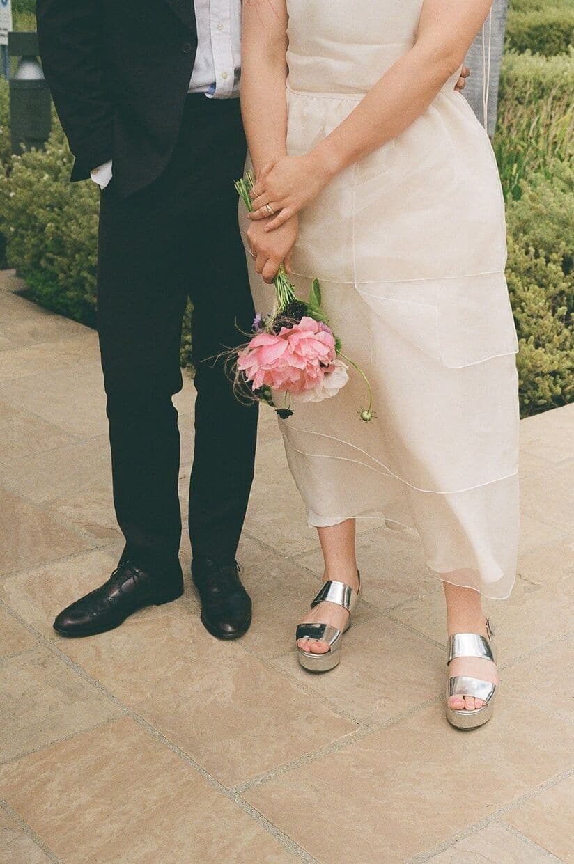 film photo of a bride and groom standing next to one another